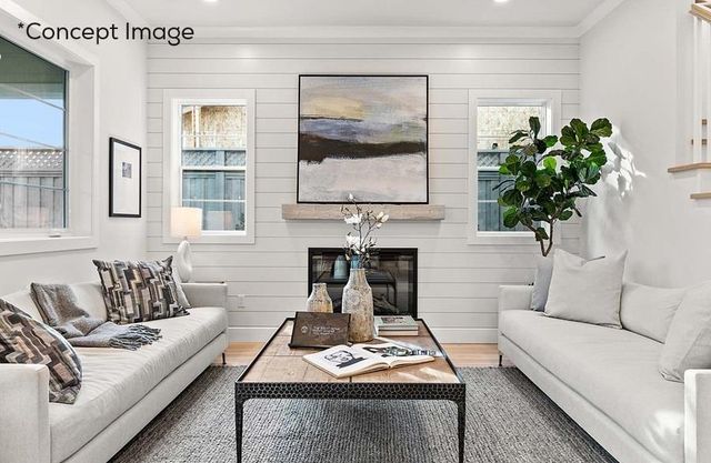 a living room with furniture a fireplace and a potted plant
