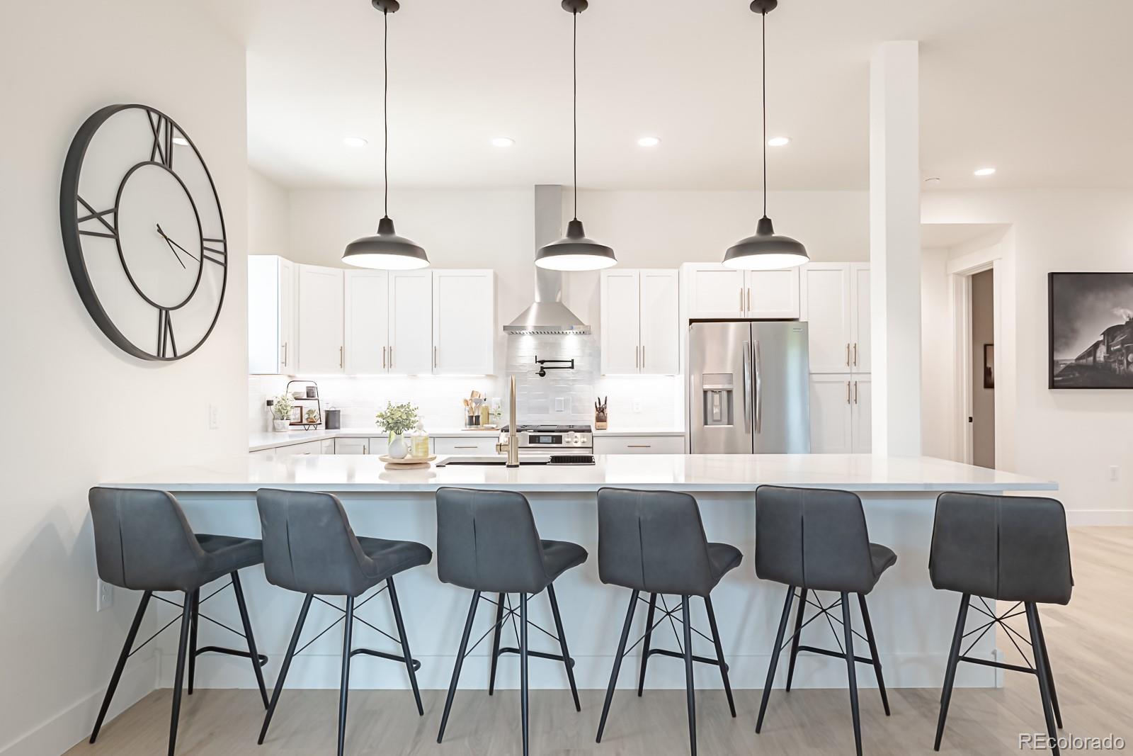 175 Whistlestop Circle Winter Park, CO 80482 - Photo 11 of 36 a kitchen with stainless steel appliances granite countertop a stove a sink and a dining table with chairs
