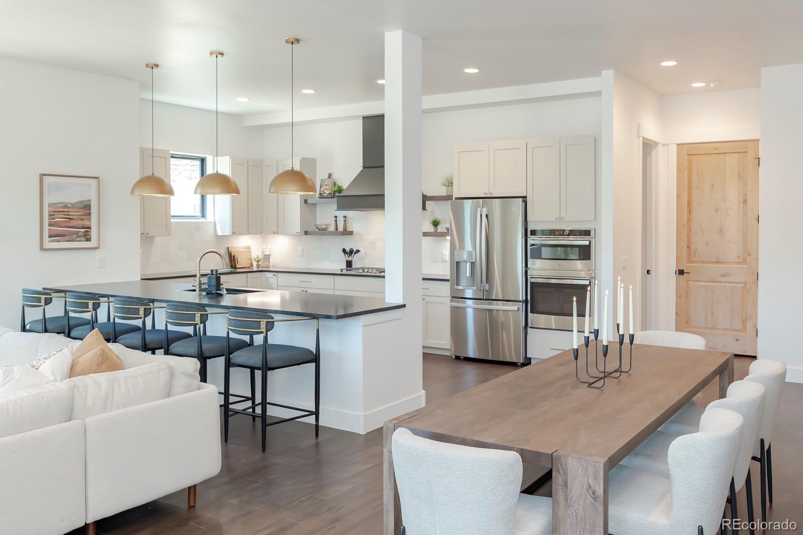 175 Whistlestop Circle Winter Park, CO 80482 - Photo 7 of 36 a kitchen with stainless steel appliances kitchen island granite countertop a table and chairs in it