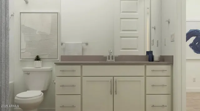 a bathroom with a toilet a sink and a mirror