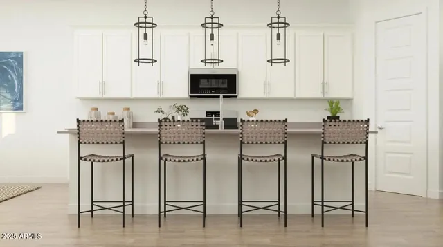 a kitchen with stainless steel appliances kitchen island granite countertop a table and chairs in it