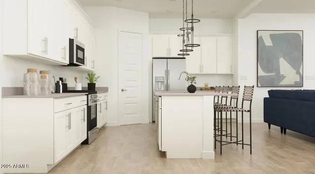 a kitchen with a refrigerator and a stove top oven