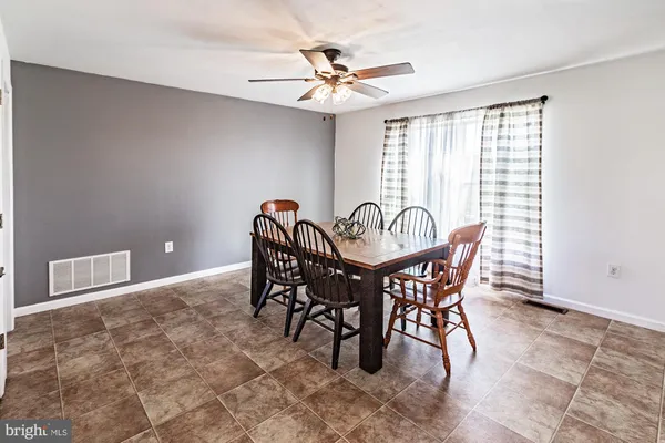 a dining room with furniture and window