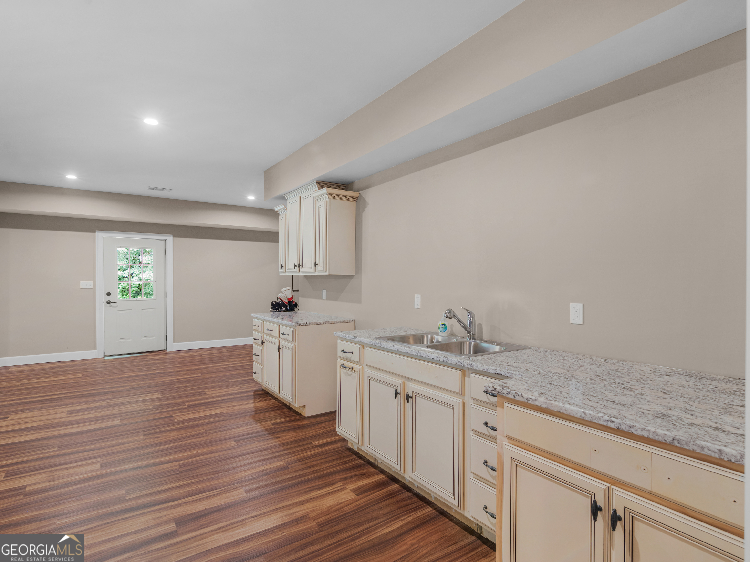 221 Hummingbird Court Hampton, GA 30228 - Photo 52 of 77 a kitchen with a sink cabinets and wooden floor