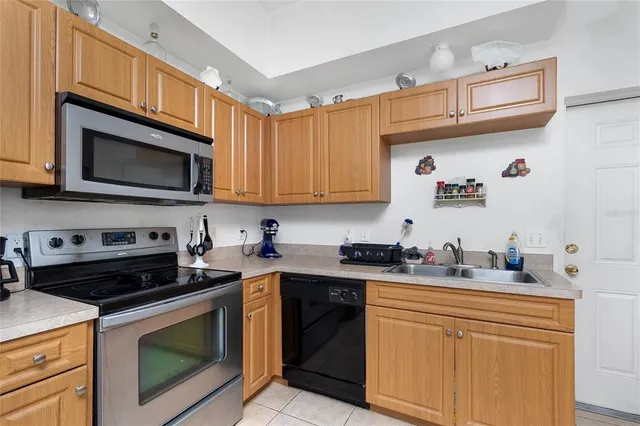 a kitchen with stainless steel appliances granite countertop a sink stove microwave and cabinets