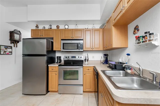 a kitchen with a sink a stove and refrigerator