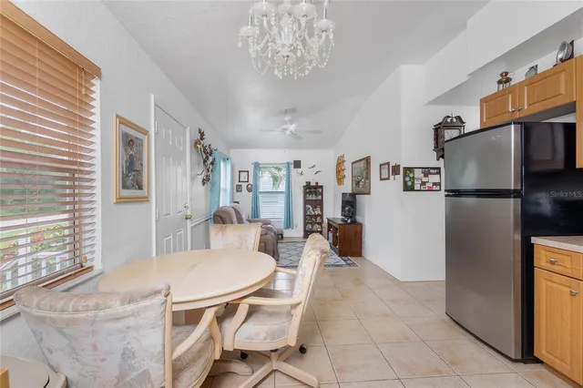 a kitchen with stainless steel appliances a table and chairs