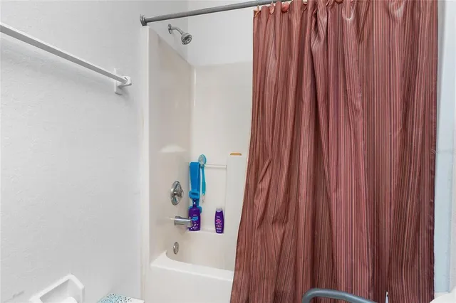 a bathroom with shower and a bathtub