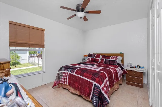 a bed sitting in a bedroom next to a window