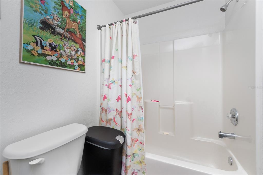 11360 Baggot Avenue Englewood, FL 34224 - Photo 25 of 31 a bathroom with a toilet and a shower curtain