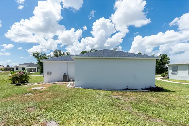 a backyard of a house with table and chairs