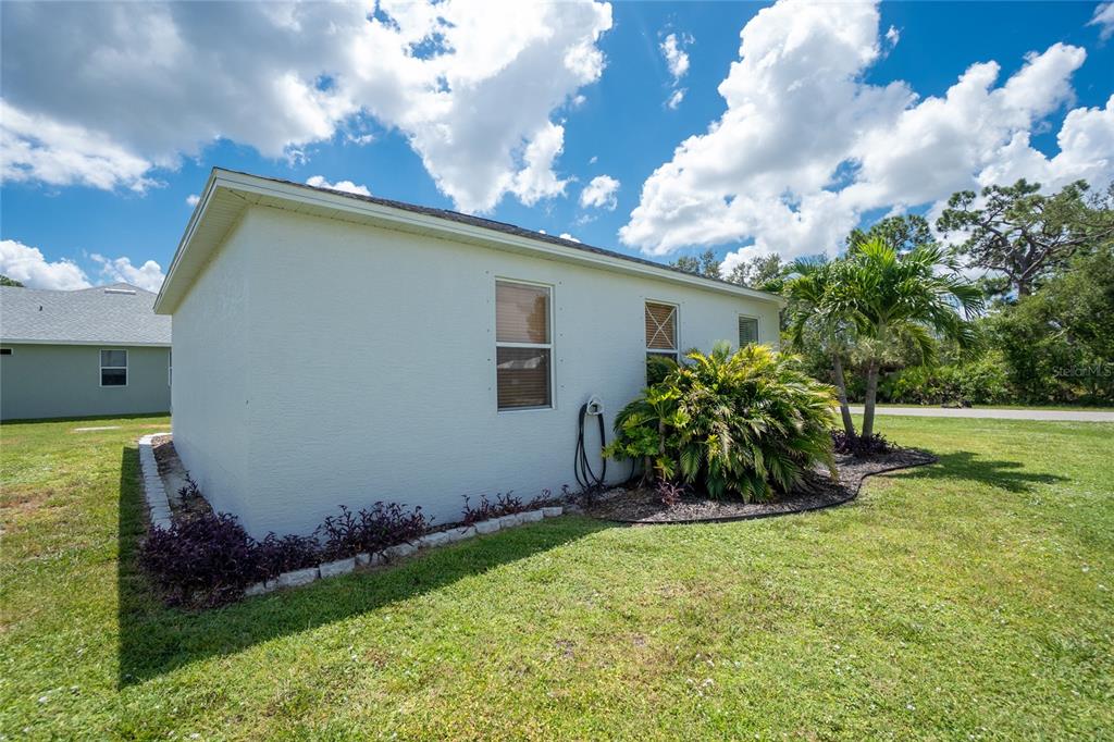 11360 Baggot Avenue Englewood, FL 34224 - Photo 30 of 31 a view of backyard with potted plants and a large tree