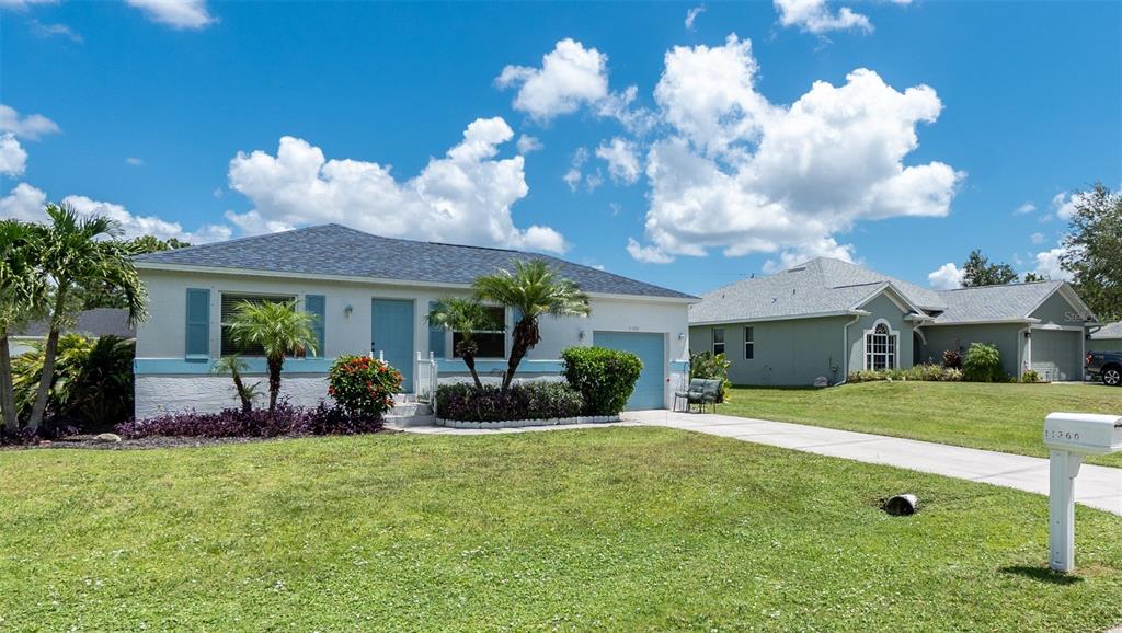 11360 Baggot Avenue Englewood, FL 34224 - Photo 31 of 31 a view of a house with a yard and a large tree