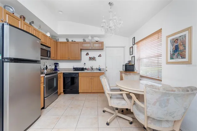 a kitchen with a table chairs sink and cabinets