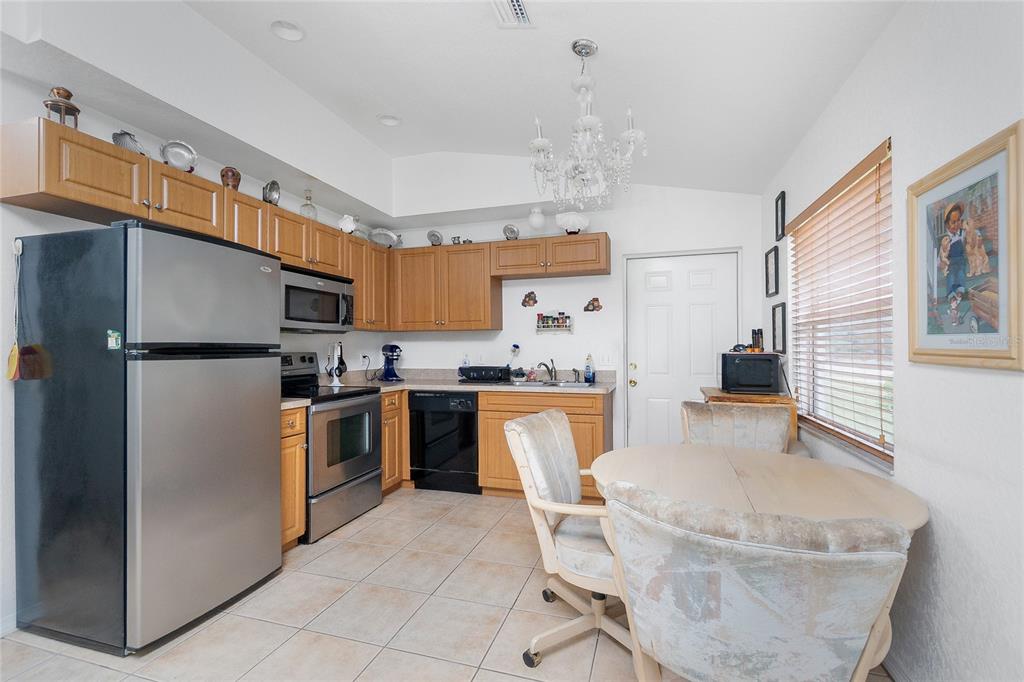 11360 Baggot Avenue Englewood, FL 34224 - Photo 10 of 31 a kitchen with granite countertop a sink appliances and cabinets