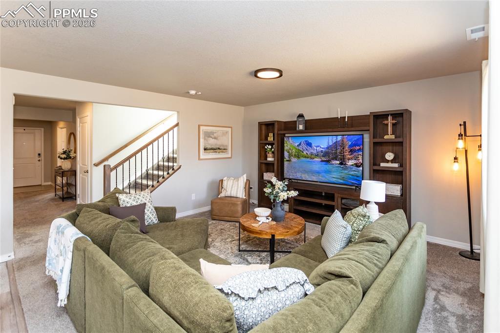 7751 Berwyn Loop Peyton, CO 80831 - Photo 13 of 50 a living room with furniture and a flat screen tv
