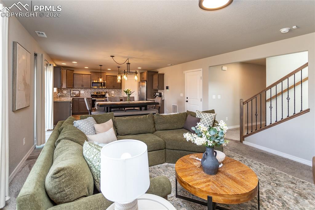 7751 Berwyn Loop Peyton, CO 80831 - Photo 15 of 50 a living room with furniture kitchen and a dining table