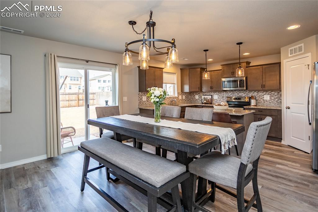 7751 Berwyn Loop Peyton, CO 80831 - Photo 18 of 50 a dining room with furniture window and wooden floor