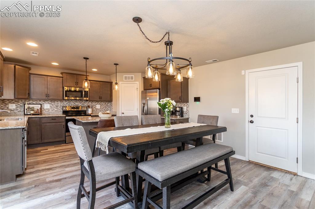 7751 Berwyn Loop Peyton, CO 80831 - Photo 19 of 50 a dining room with furniture and window