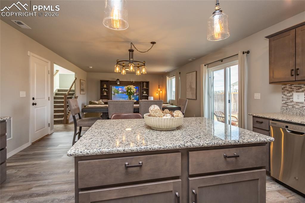 7751 Berwyn Loop Peyton, CO 80831 - Photo 22 of 50 a kitchen with granite countertop a stove and cabinets