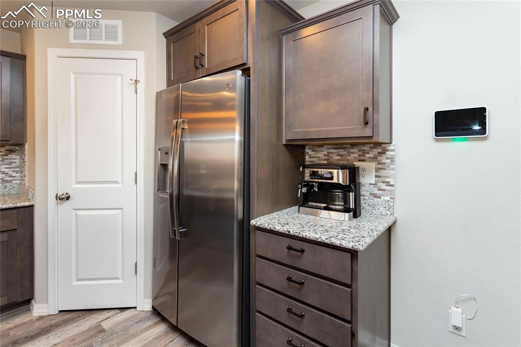 7751 Berwyn Loop Peyton, CO 80831 - Photo 24 of 50 a kitchen with granite countertop cabinets and refrigerator