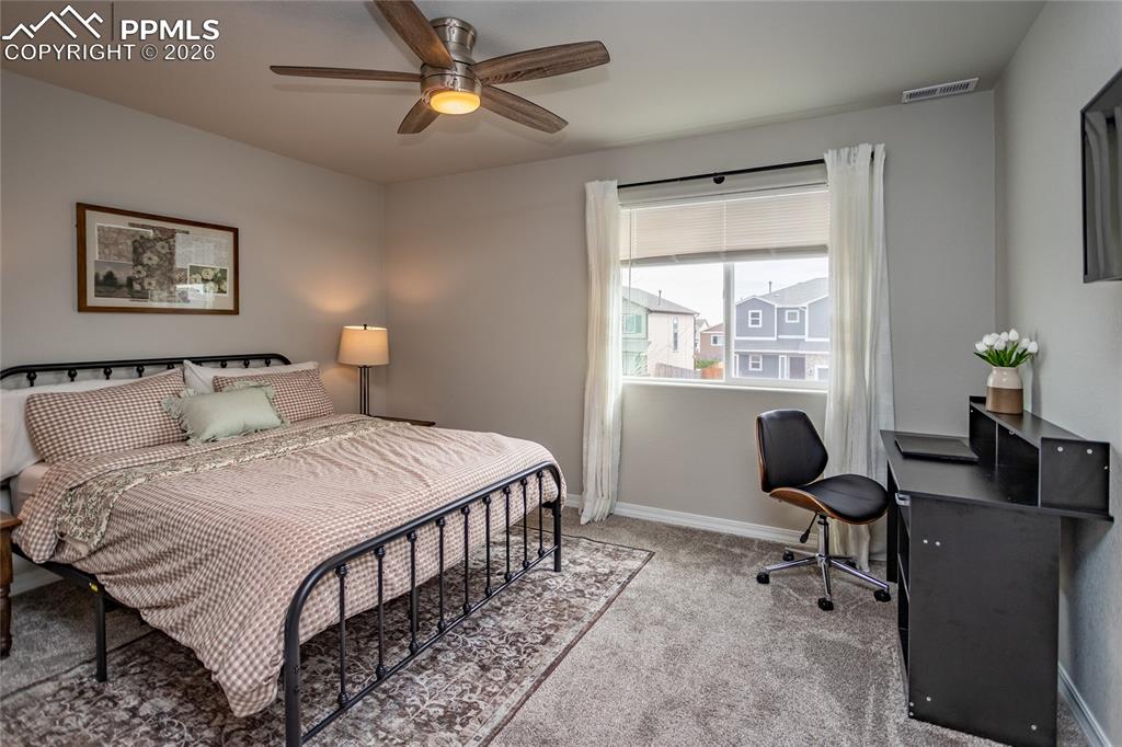 7751 Berwyn Loop Peyton, CO 80831 - Photo 25 of 50 a bedroom with a bed and a desk