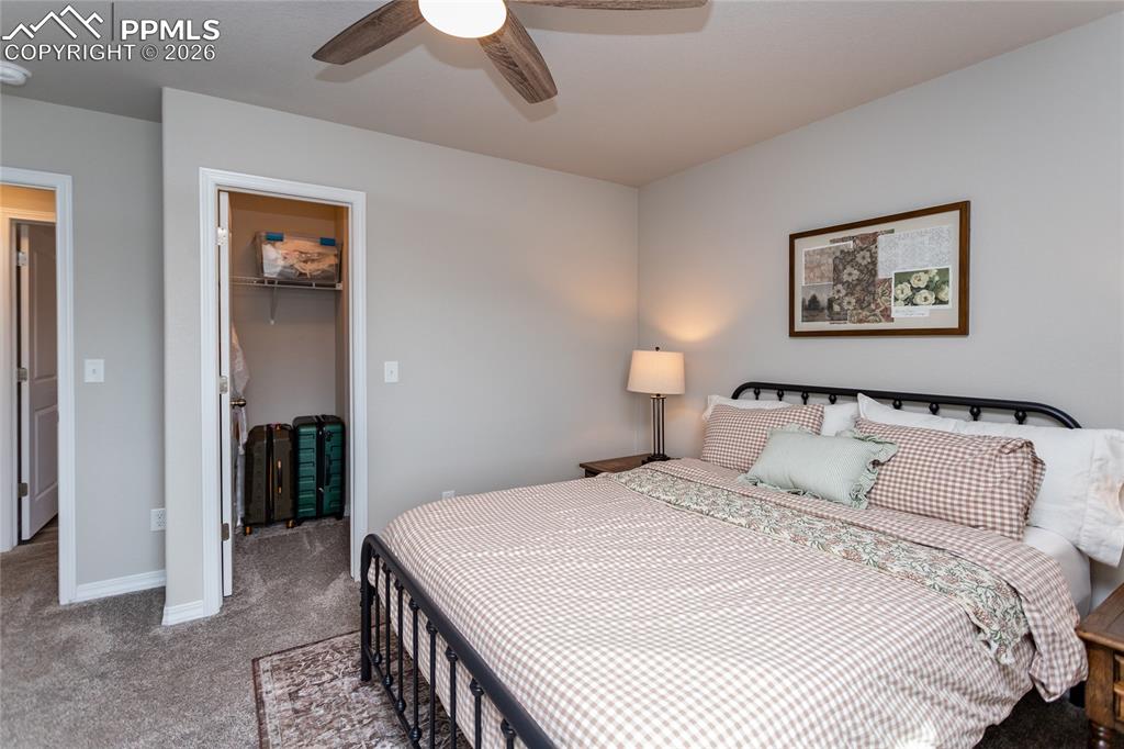 7751 Berwyn Loop Peyton, CO 80831 - Photo 26 of 50 a bedroom with a bed and a painting on the wall