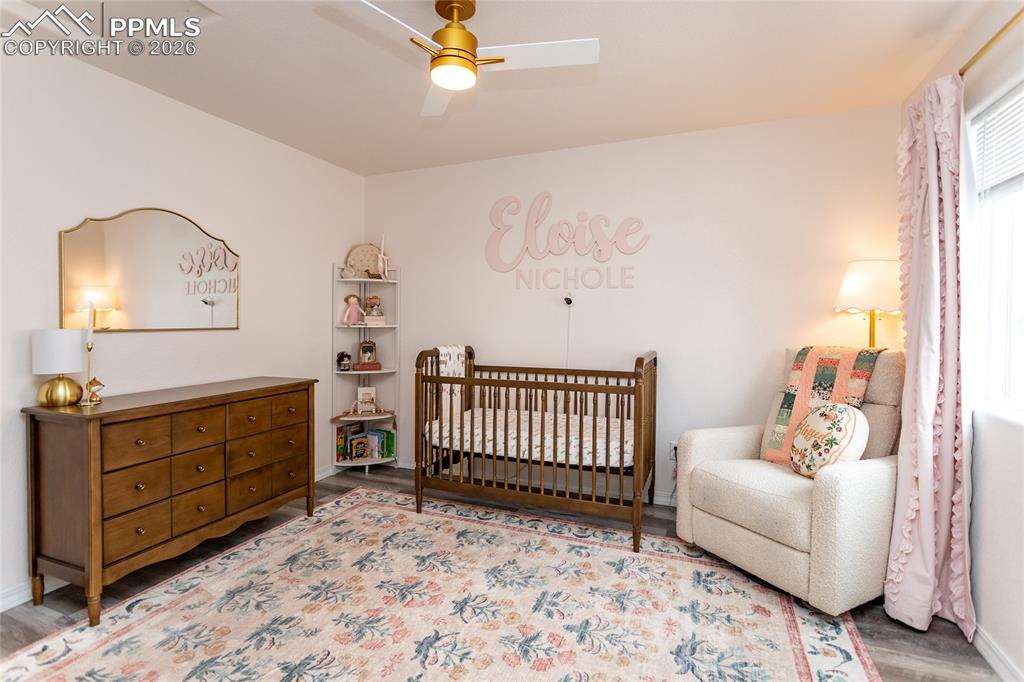 7751 Berwyn Loop Peyton, CO 80831 - Photo 28 of 50 a bedroom with a bed and a chandelier