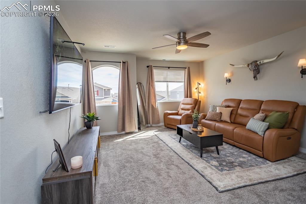 7751 Berwyn Loop Peyton, CO 80831 - Photo 31 of 50 a living room with furniture and a large window