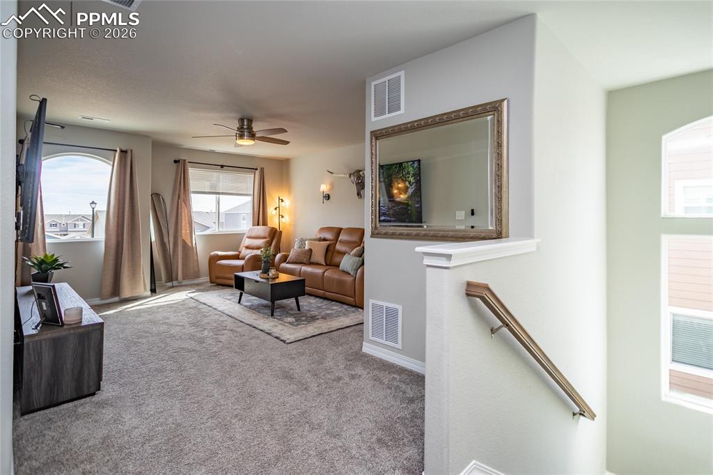 7751 Berwyn Loop Peyton, CO 80831 - Photo 32 of 50 a living room with furniture and a flat screen tv