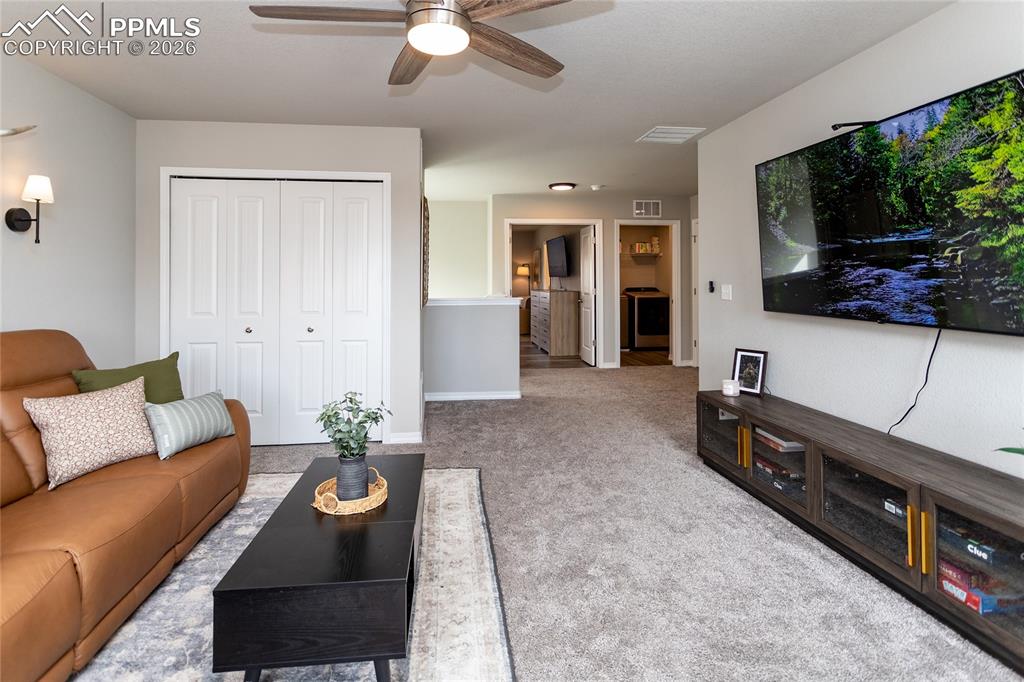 7751 Berwyn Loop Peyton, CO 80831 - Photo 34 of 50 a living room with furniture and a flat screen tv