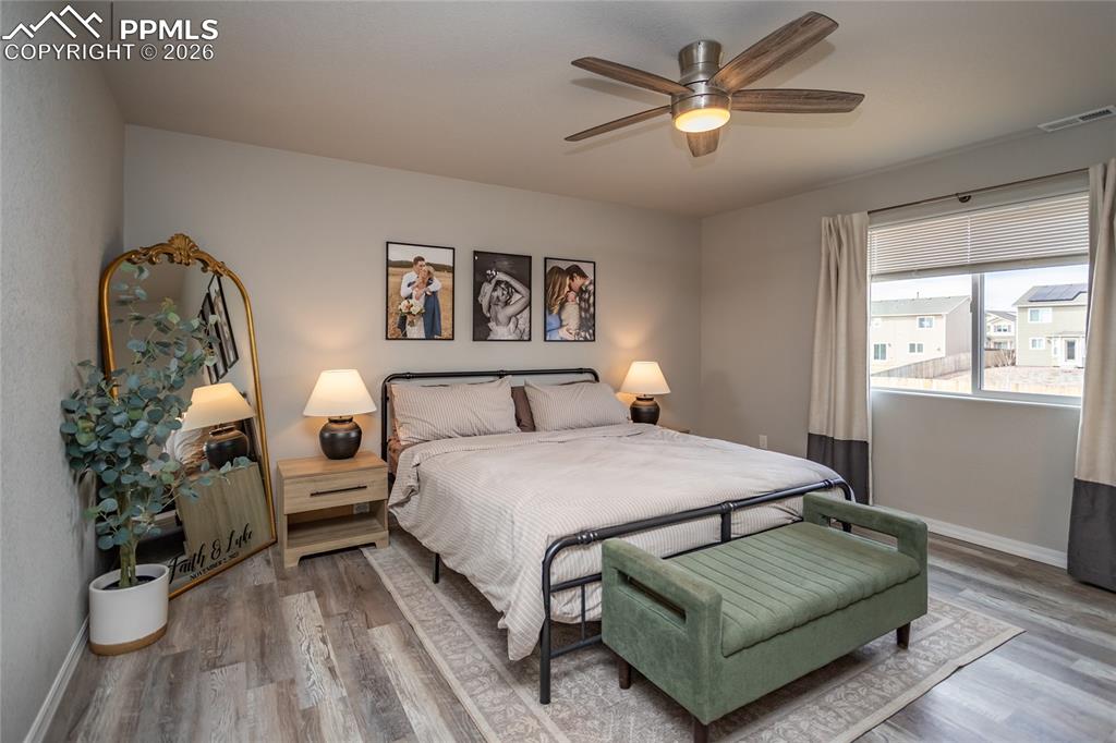 7751 Berwyn Loop Peyton, CO 80831 - Photo 38 of 50 a bedroom with a bed couch and a window