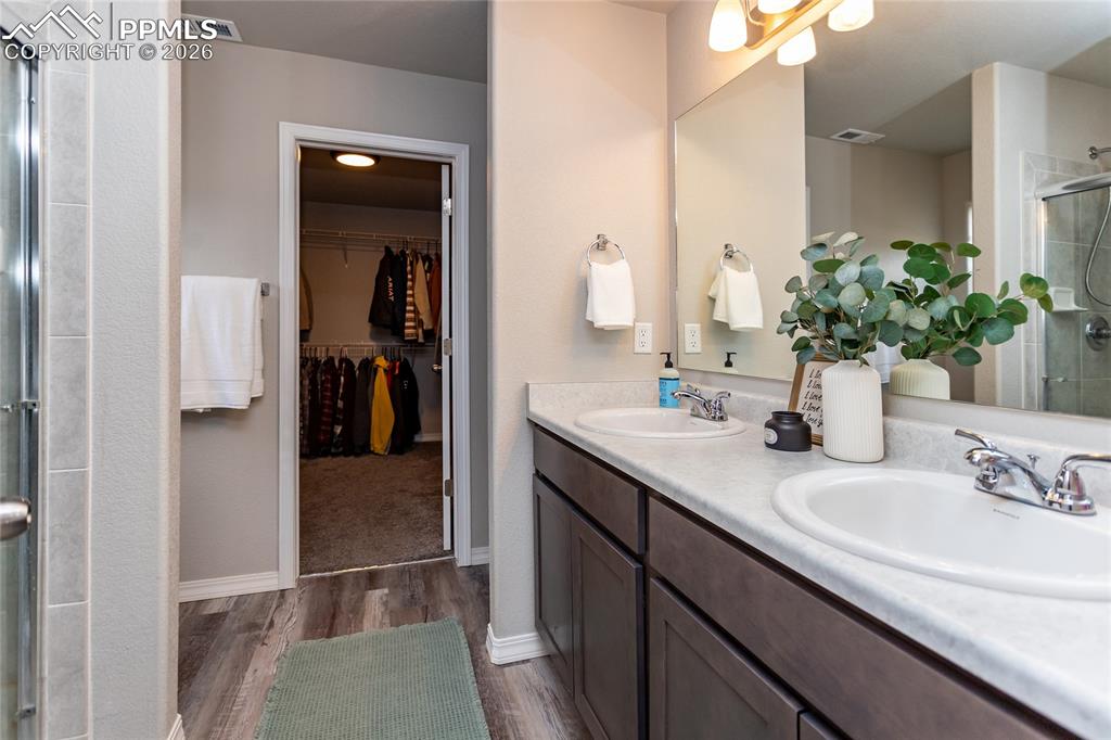 7751 Berwyn Loop Peyton, CO 80831 - Photo 40 of 50 a bathroom with a sink and a mirror