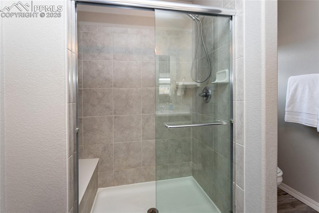 7751 Berwyn Loop Peyton, CO 80831 - Photo 41 of 50 a bathroom with a glass shower door