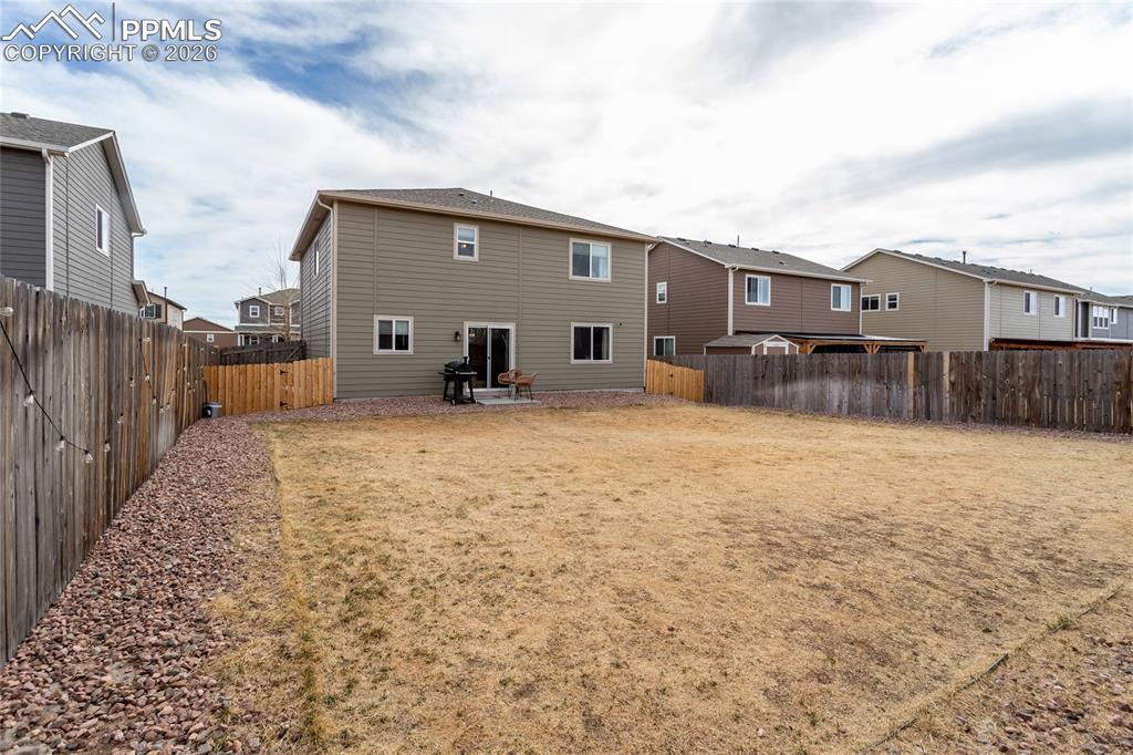 7751 Berwyn Loop Peyton, CO 80831 - Photo 46 of 50 a view of a backyard with a large tree