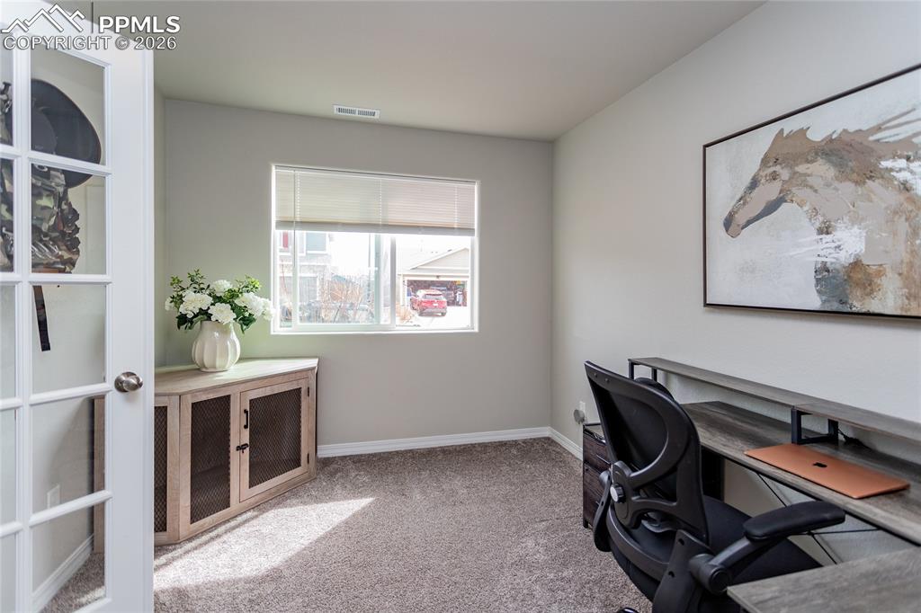 7751 Berwyn Loop Peyton, CO 80831 - Photo 8 of 50 a view of a workspace with furniture and a window