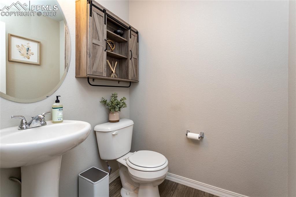 7751 Berwyn Loop Peyton, CO 80831 - Photo 10 of 50 a bathroom with a toilet a sink and mirror