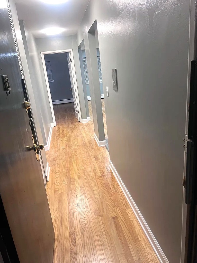 6619 North Sheridan Road, Unit 305 Chicago, IL 60626 - Photo 7 of 10 a view of a hallway with wooden floor and staircase