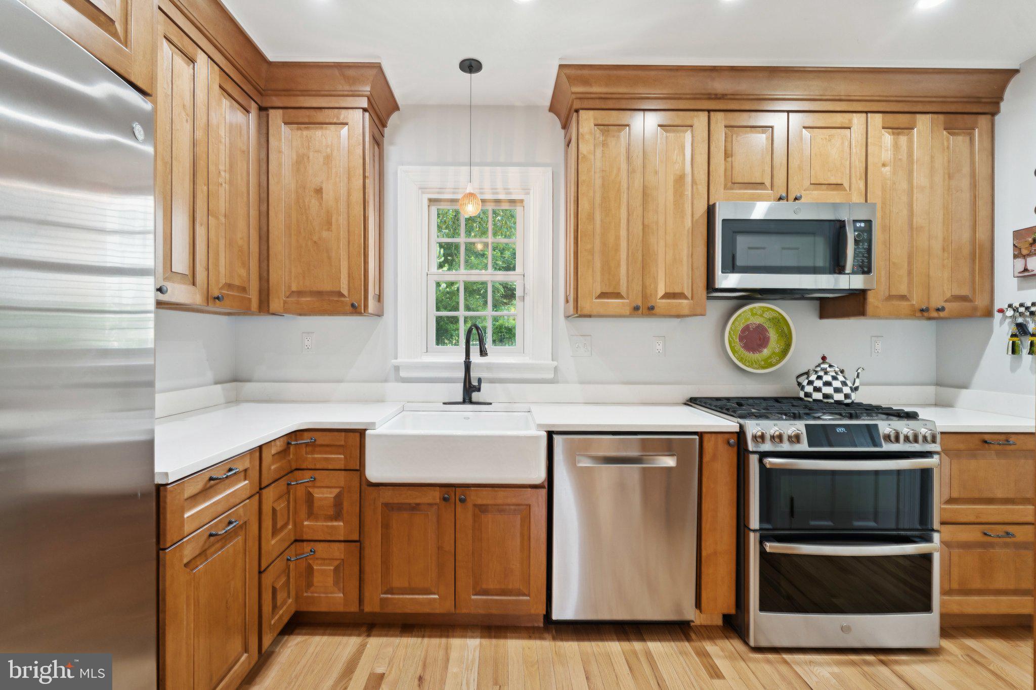 3666 Military Road Arlington, VA 22207 - Photo 17 of 69 a kitchen with stainless steel appliances granite countertop a stove a sink and a microwave