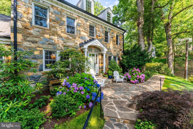 a front view of a house with a yard and fountain in middle of the house