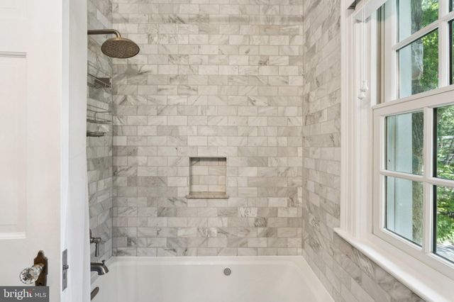 a bathroom with a glass shower door