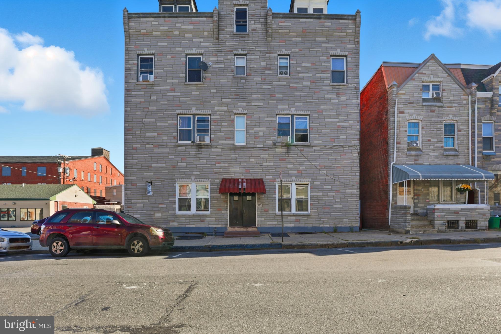 a car parked in front of a brick building