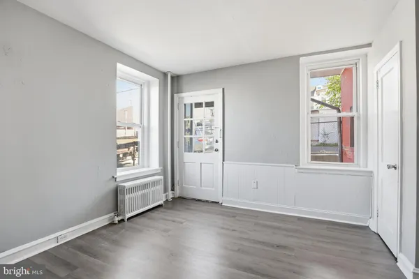 an empty room with windows and closet