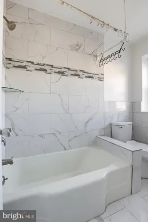 a bathroom with a bathtub and a shower