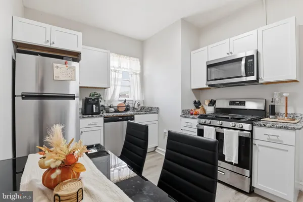 a kitchen with stainless steel appliances a refrigerator stove and microwave