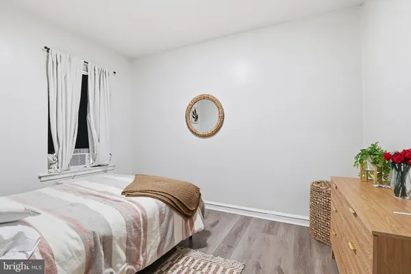 a bedroom with a bed and a potted plant