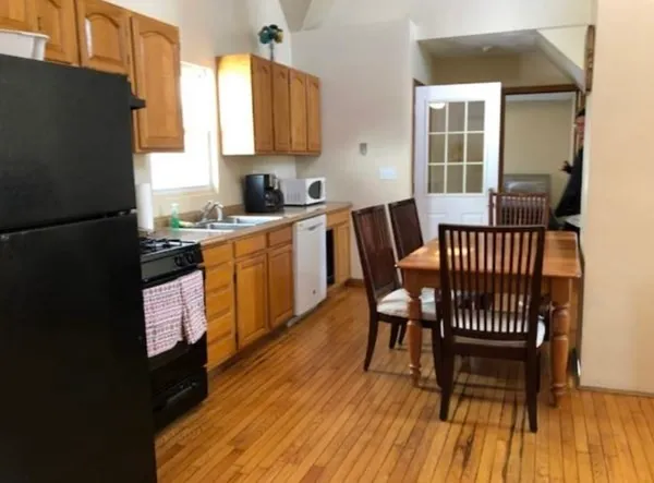 a kitchen with a table chairs and a refrigerator