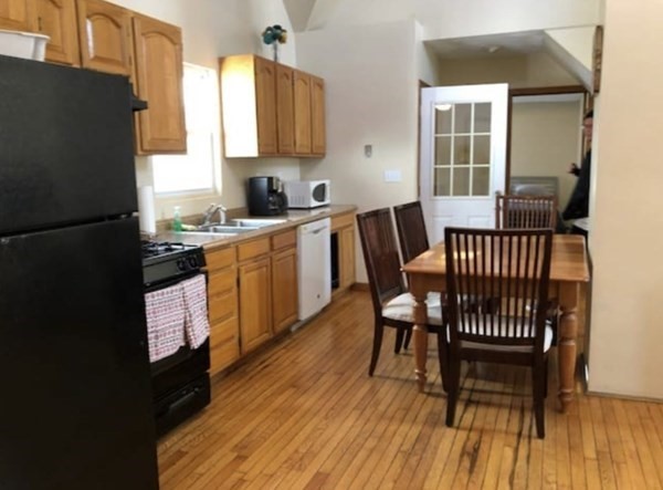 a kitchen with a table chairs and a refrigerator