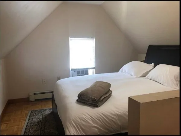 a bedroom with a bed and a window