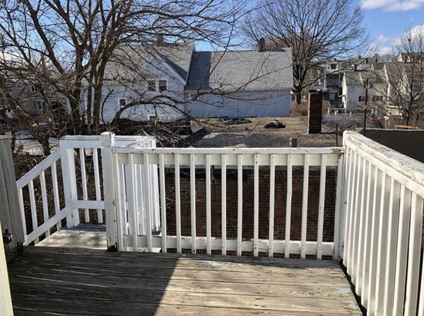 138 Ferry Street, Unit 2 Everett, MA 02149 - Photo 18 of 18 a view of a house with a wooden fence